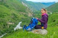 Girl with a backpack in the mountains. Panorama.