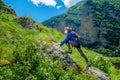 A girl with a backpack is resting in the mountains. Panorama of the Caucasus Mountains.