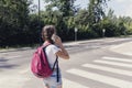 Girl using smartphone while walking through pedestrian crossing Royalty Free Stock Photo