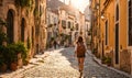 Girl with backpack walking on cobblestone street