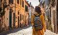 Girl with backpack walking on cobblestone street