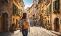 Girl with backpack walking on cobblestone street