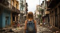 a girl with a backpack walking down a dirty street