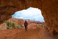 Girl Backpacker under Sandstone Arch Peek-a-boo Bryce Royalty Free Stock Photo