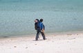 Girl backpacker walking on a beach