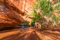 Girl Backpacker walking under Natural Bridge Arch Coyote Gulch Royalty Free Stock Photo