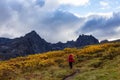 Girl Backpacking on Scenic Hiking Trail surrounded by Rugged Mountains