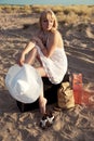 Girl with baggage at the sand