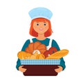 Girl baker holds a basket with fresh bread