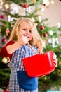 Girl baking cookies in front of Christmas tree Royalty Free Stock Photo