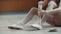 Girl balerina dancer putting on her ballet shoes Royalty Free Stock Photo