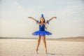 Girl ballerina dancer in a  blue  dress on a snow-white salty dried lake. Fantastic landscape and a girl in red punata and a pink Royalty Free Stock Photo