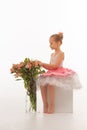 Girl ballerina in a tutu with flowers