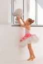 Girl ballerina in a tutu by the window Royalty Free Stock Photo