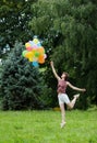 girl with balloons on a green grass Royalty Free Stock Photo