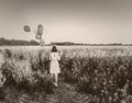 Girl with balloons in the field old photo style Royalty Free Stock Photo