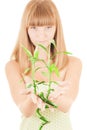 Girl with bamboo sprout Royalty Free Stock Photo