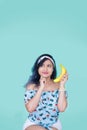 Girl talking with a banana. Yellow makeup. Fun Royalty Free Stock Photo