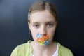 Girl with bandages over her mouth Royalty Free Stock Photo