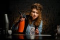 Girl at bar holds siphon in her hand. Royalty Free Stock Photo