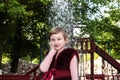 A girl in a bardova fur coat on the background of a fountain. Children Of Donbass. War and peace. Beautiful child Royalty Free Stock Photo