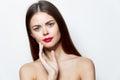 Girl bare shoulders Holds a hand near Faces red lips attractive look
