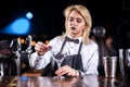 Girl barman creates a cocktail in the bar