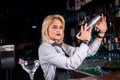 Girl barman mixes a cocktail in the beerhouse