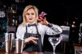 Girl bartender concocts a cocktail in the beerhall