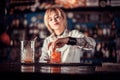 Girl bartender concocts a cocktail at the beerhouse Royalty Free Stock Photo