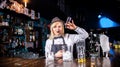 Girl bartender mixes a cocktail in the beerhall