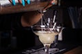 Girl bartender pours cocktail into glass. Close-up. Royalty Free Stock Photo