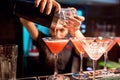 The girl bartender prepares a cocktail in the nightclub