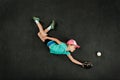 Girl baseball player making a diving catch