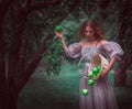 A girl with a basket with apples in a fairy forest Royalty Free Stock Photo