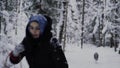 Girl with a basket in the winter forest runs away from husky, husky girl pursues.