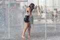 Girl bathe in the fountain in hot day