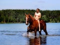 Girl bathe horse in the lake.