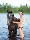 Girl bathe horse in a river