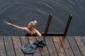 The girl bathes in the forest lake in the rain in summer Royalty Free Stock Photo