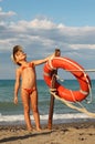 Girl in bathing suit and cap standing on beach Royalty Free Stock Photo