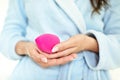 The girl in the bathroom, in a blue robe makes makeup with pink beauty blender, woman holds a brush cosmetics, sponge Konjac, Royalty Free Stock Photo