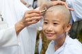 Girl be removed hair to become a nun during a Buddhist ordination