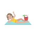 Girl On Beach Blanket With Plastic Bucket Of Toys