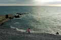 Girl on the beach, child, in a pink jacket, children play Royalty Free Stock Photo