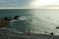 Girl on the beach, child, in a pink jacket, children play