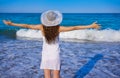 Girl with beach hat in sea open arms Royalty Free Stock Photo