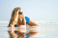 Girl on beach with reflection in water Royalty Free Stock Photo