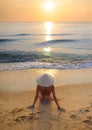 girl on beach at sunset wearing rice hat 3