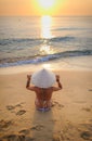 girl on beach at sunset wearing a rice-hat 2